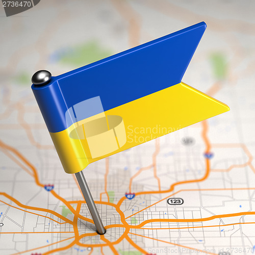 Image of Ukraine Small Flag on a Map Background.