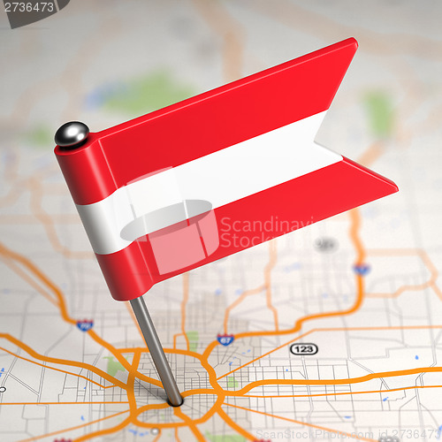 Image of Austria Small Flag on a Map Background.