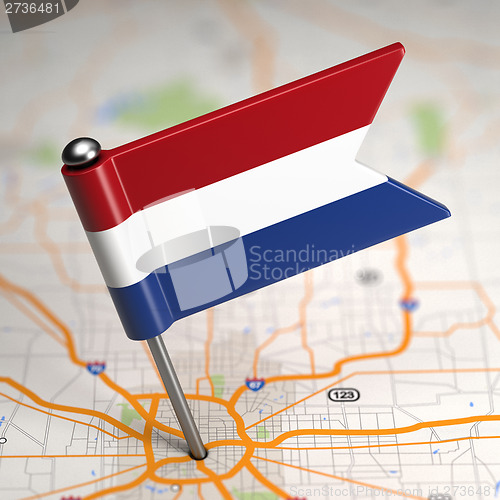 Image of Netherlands Small Flag on a Map Background.