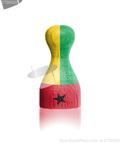 Image of Wooden pawn with a flag painting