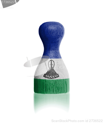 Image of Wooden pawn with a flag painting