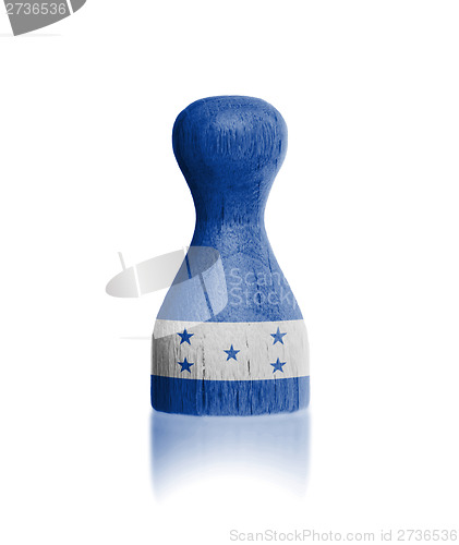 Image of Wooden pawn with a flag painting