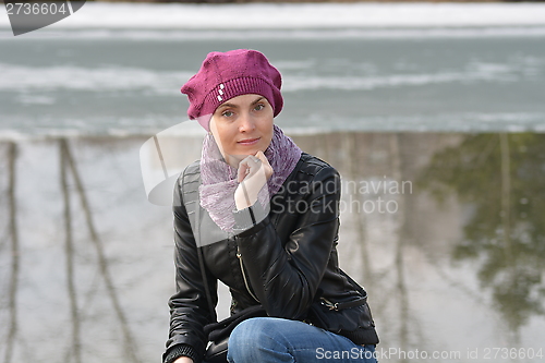 Image of Woman in pink beret and black leather jacket 