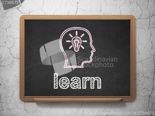 Image of Education concept: Head With Lightbulb and Learn on chalkboard