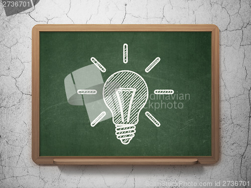 Image of Finance concept: Light Bulb on chalkboard background