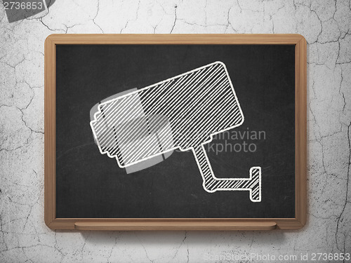 Image of Protection concept: Cctv Camera on chalkboard background