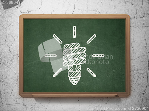 Image of Finance concept: Energy Saving Lamp on chalkboard background