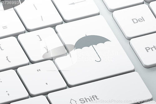 Image of Security concept: Umbrella on computer keyboard background