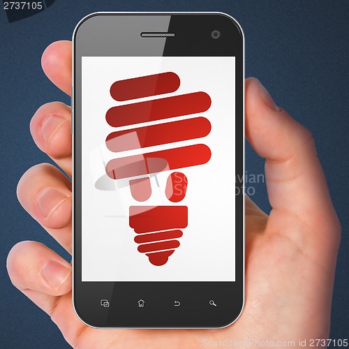 Image of Finance concept: Energy Saving Lamp on smartphone