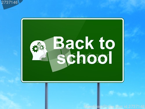 Image of Education concept: Back to School and Head With Gears on road sign background