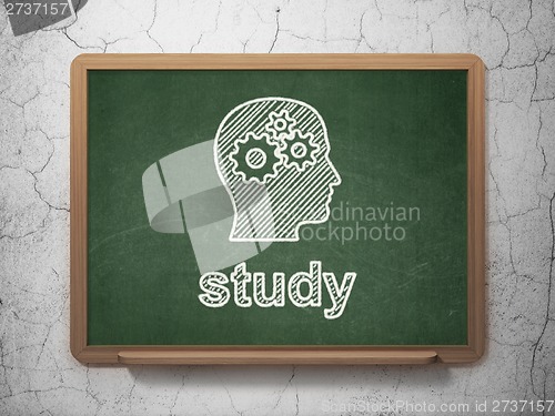 Image of Education concept: Head With Gears and Study on chalkboard background