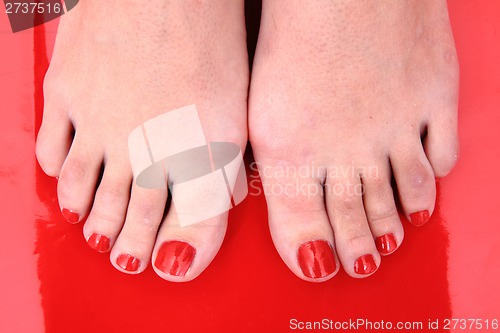 Image of red nails on the feet 