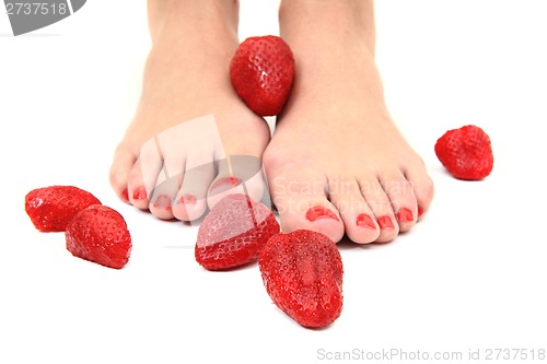 Image of woman feet and strawberries