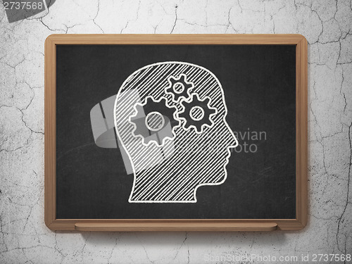 Image of Marketing concept: Head With Gears on chalkboard background