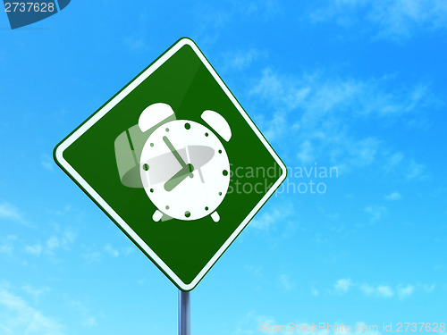 Image of Timeline concept: Alarm Clock on road sign background