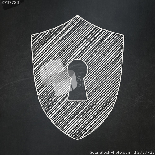 Image of Protection concept: Shield With Keyhole on chalkboard background
