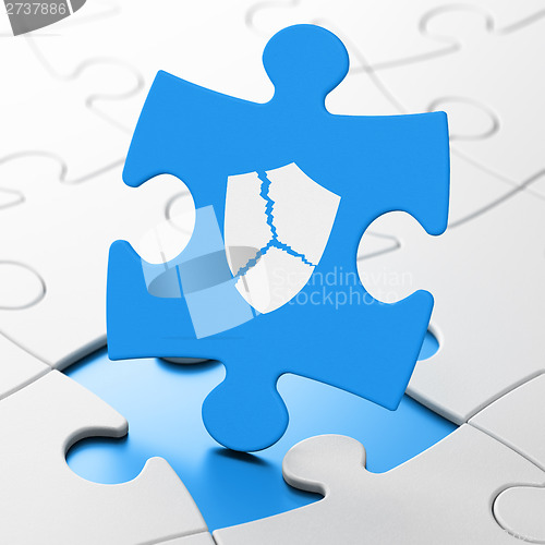 Image of Safety concept: Broken Shield on puzzle background