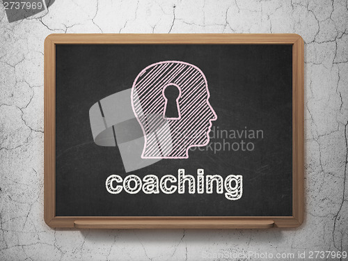 Image of Education concept: Head With Keyhole Coaching on chalkboard