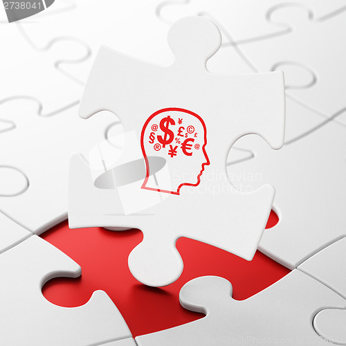 Image of Marketing concept: Head With Finance Symbol on puzzle background