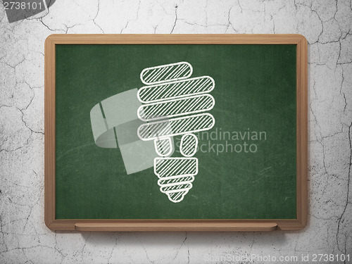 Image of Finance concept: Energy Saving Lamp on chalkboard background