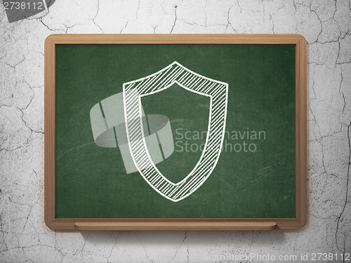 Image of Protection concept: Contoured Shield on chalkboard background