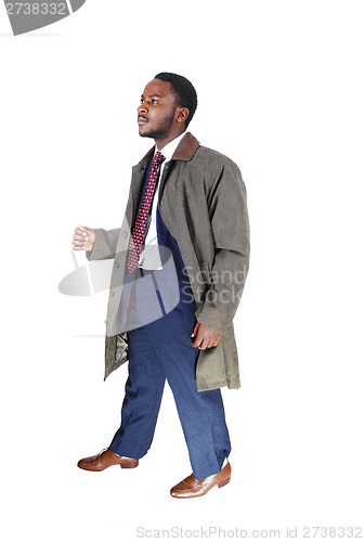 Image of Man in coat walking.