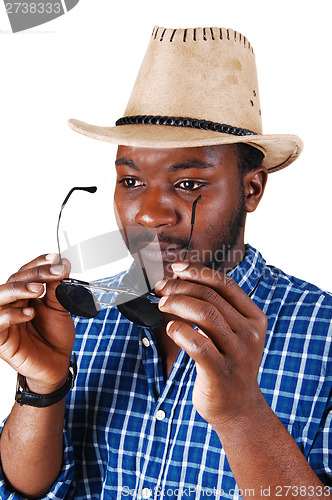 Image of Black man with hat and glasses.