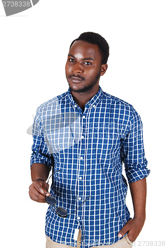 Image of Black man holding sunglasses.