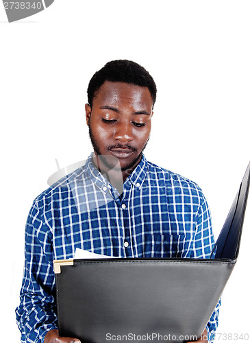 Image of Black man reading paper.