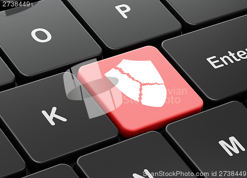 Image of Safety concept: Broken Shield on computer keyboard background