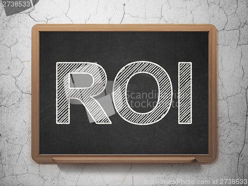 Image of Business concept: ROI on chalkboard background