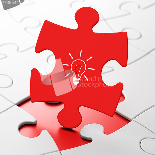 Image of Finance concept: Light Bulb on puzzle background