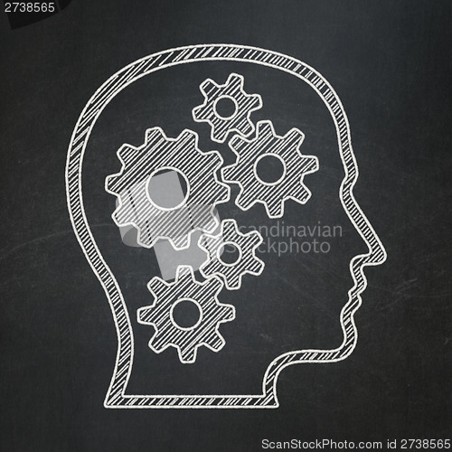 Image of Education concept: Head With Gears on chalkboard background