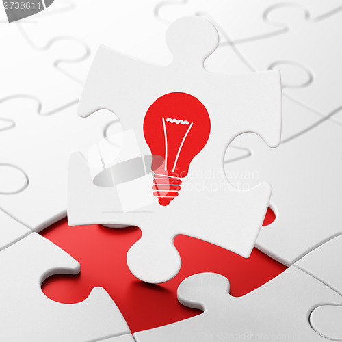 Image of Business concept: Light Bulb on puzzle background