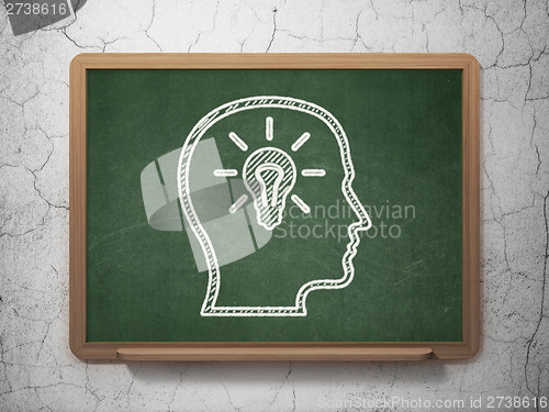 Image of Education concept: Head With Lightbulb on chalkboard background