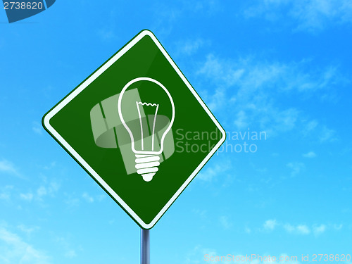 Image of Finance concept: Light Bulb on road sign background