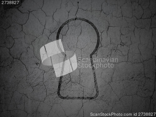 Image of Data concept: Keyhole on grunge wall background