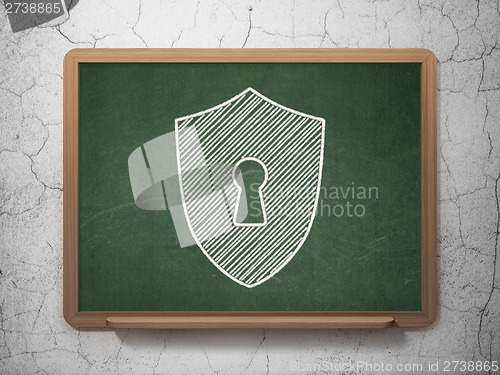 Image of Protection concept: Shield With Keyhole on chalkboard background