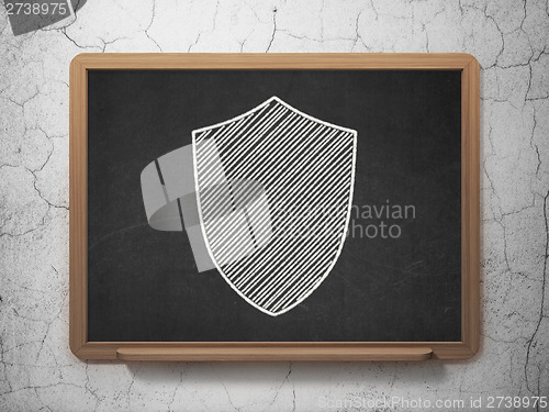 Image of Protection concept: Shield on chalkboard background