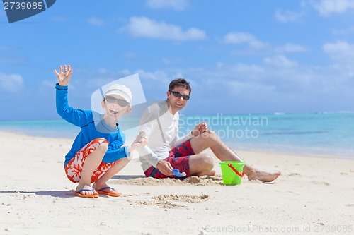 Image of family building sand castle