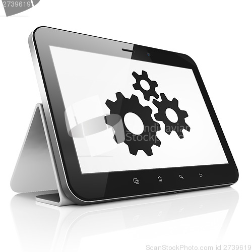 Image of Information concept: Gears on tablet pc computer