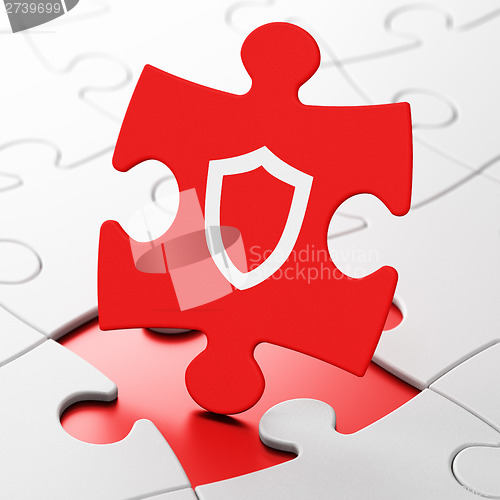 Image of Security concept: Contoured Shield on puzzle background