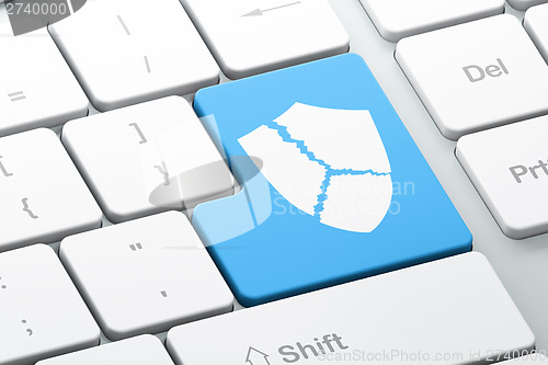 Image of Security concept: Broken Shield on computer keyboard background