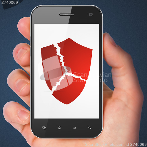 Image of Security concept: Broken Shield on smartphone