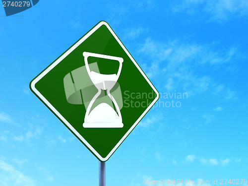 Image of Timeline concept: Hourglass on road sign background