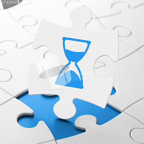 Image of Time concept: Hourglass on puzzle background