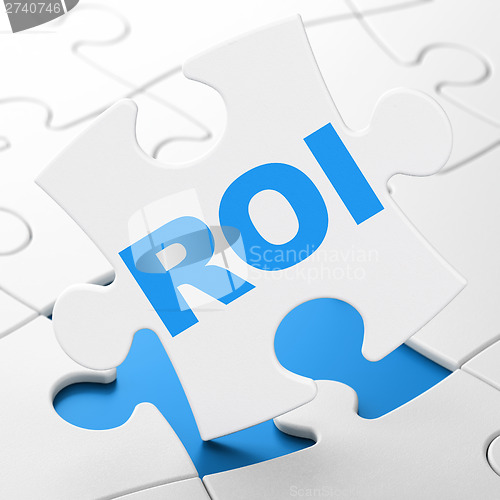 Image of Business concept: ROI on puzzle background