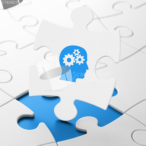 Image of Finance concept: Head With Gears on puzzle background