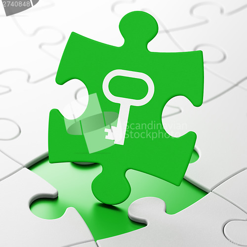 Image of Protection concept: Key on puzzle background