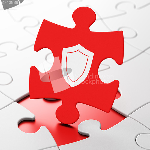 Image of Protection concept: Shield on puzzle background